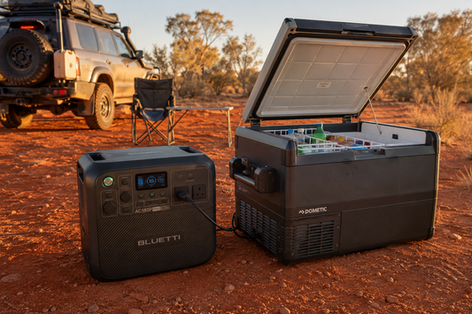 BLUETTI portable power station connected to a Dometic camping fridge at an Australian outback campsite with a 4WD in the background