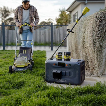 BLUETTI APEX 300 powering outdoor garden equipment with outlet covers open