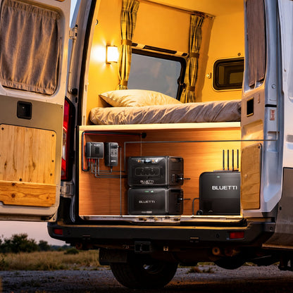 Official BLUETTI Charger 2 promotional campervan setup at dusk with solar panels, power stations and optional DC Hub; accessories sold separately