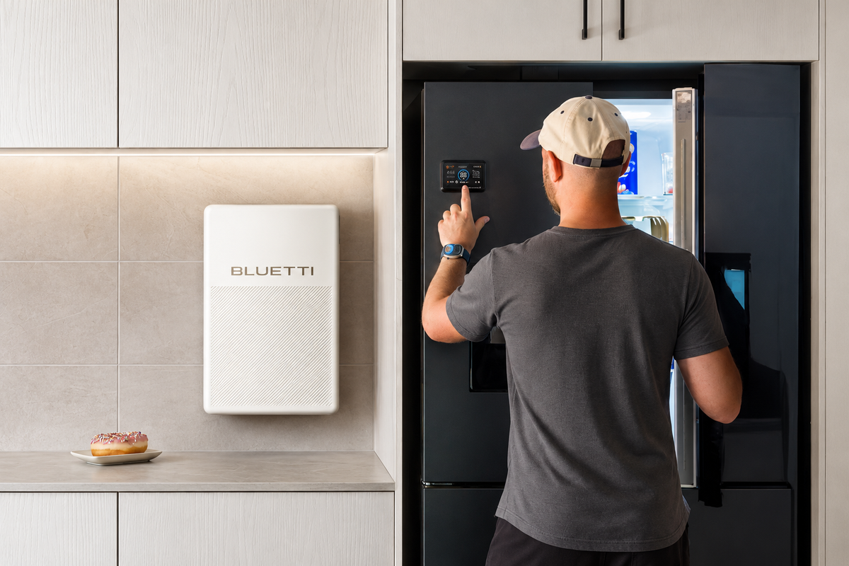 BLUETTI FridgePower wall-mounted beside a refrigerator; single unit installation example, appliances not included